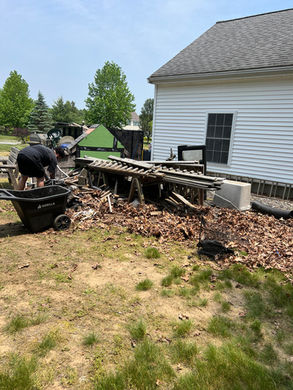 Coastal Junk Removal Solutions had cleaned up a yard that had construction debris and old furniture to throw in the dumpster.