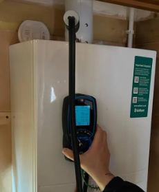 Gas engineer in Watford testing a Vaillant boiler.