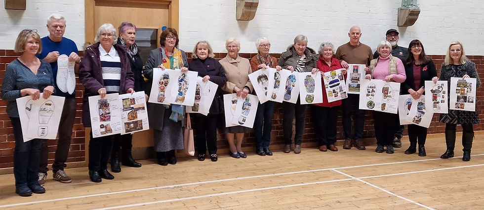 A group of people holding artwork they have made