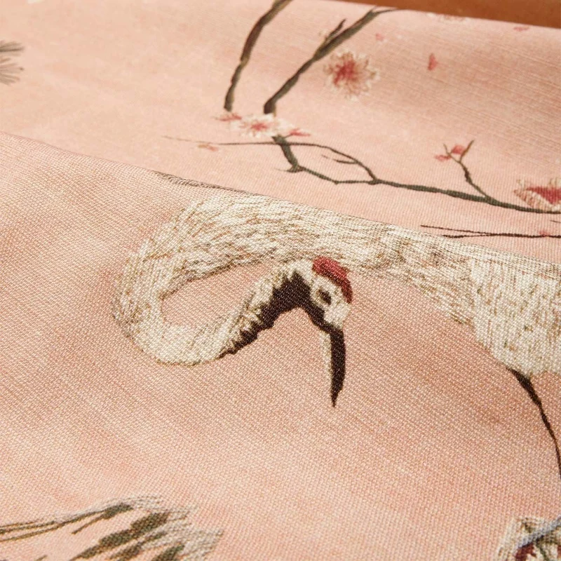 détail de tissu imprimé d'un oiseau sur fond rose