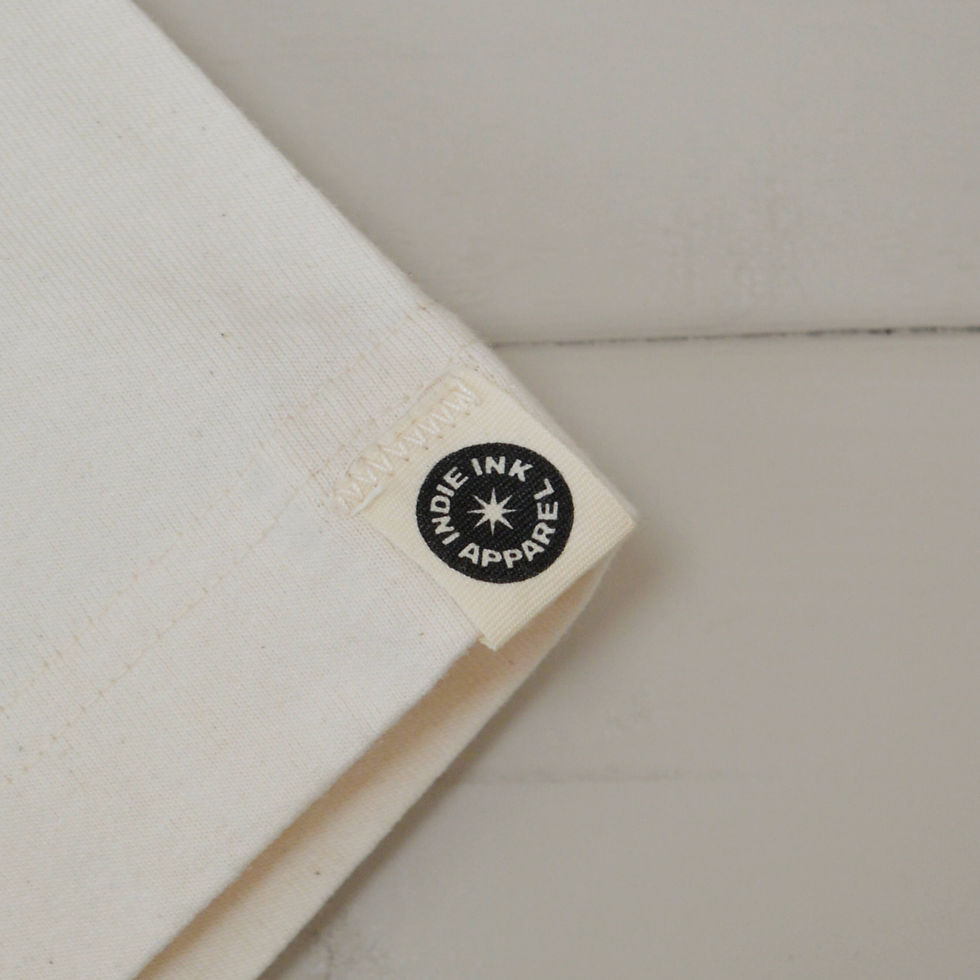 Thumbnail: Close up of a hem tag with an Indie Ink Apparel logo
