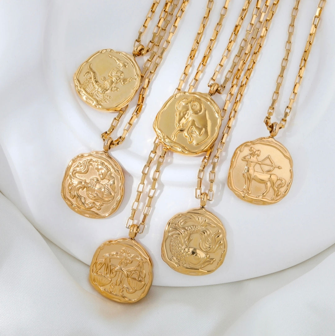 Six gold talismans with embossed coin pendants