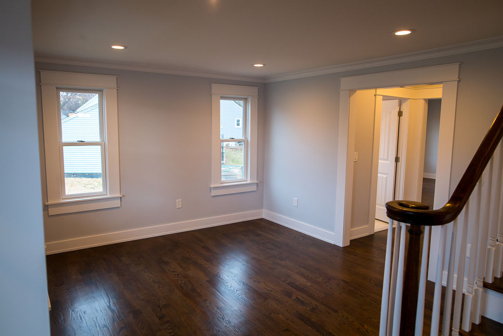 Interior view of a renovated space in Ridgewood, NJ with hardwood floors and large windows