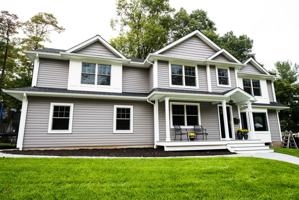 Gray two-story house with white trim and porch.
