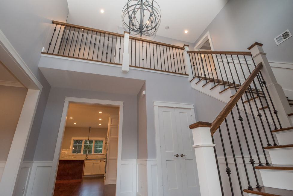Modern interior with staircase and spherical chandelier.