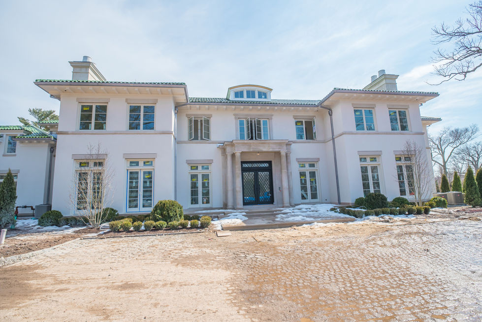 Large, elegant mansion with symmetrical architecture.