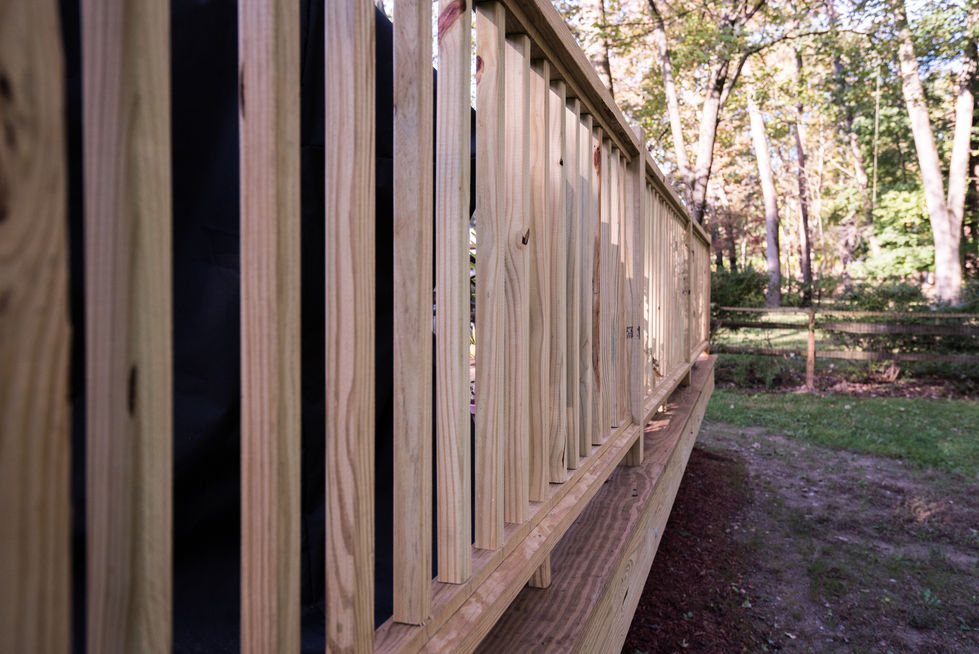 Wooden fence with vertical slats in outdoor setting.