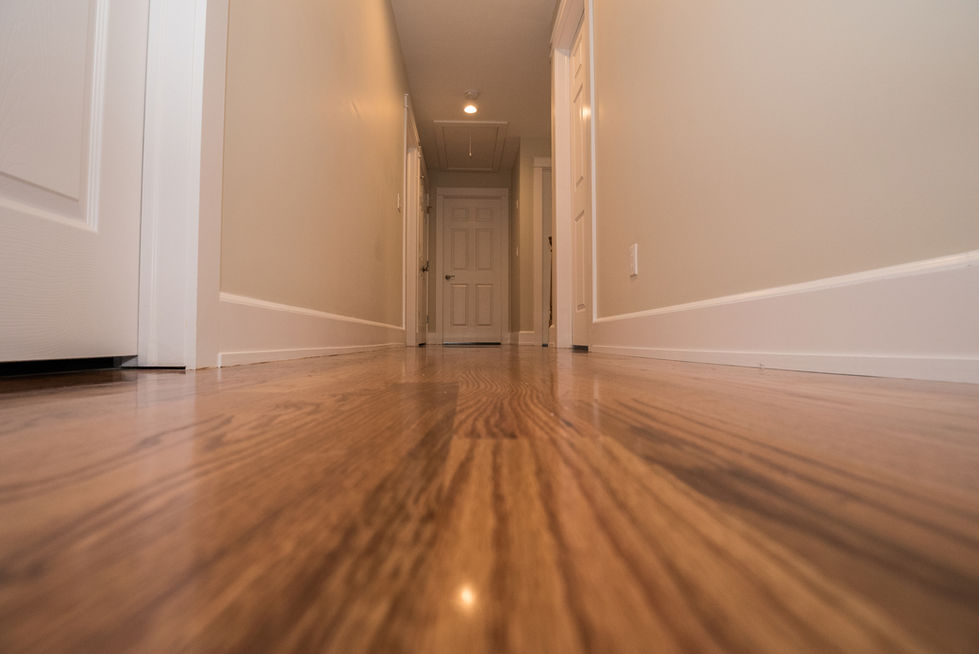 Polished wooden floor in a narrow hallway.