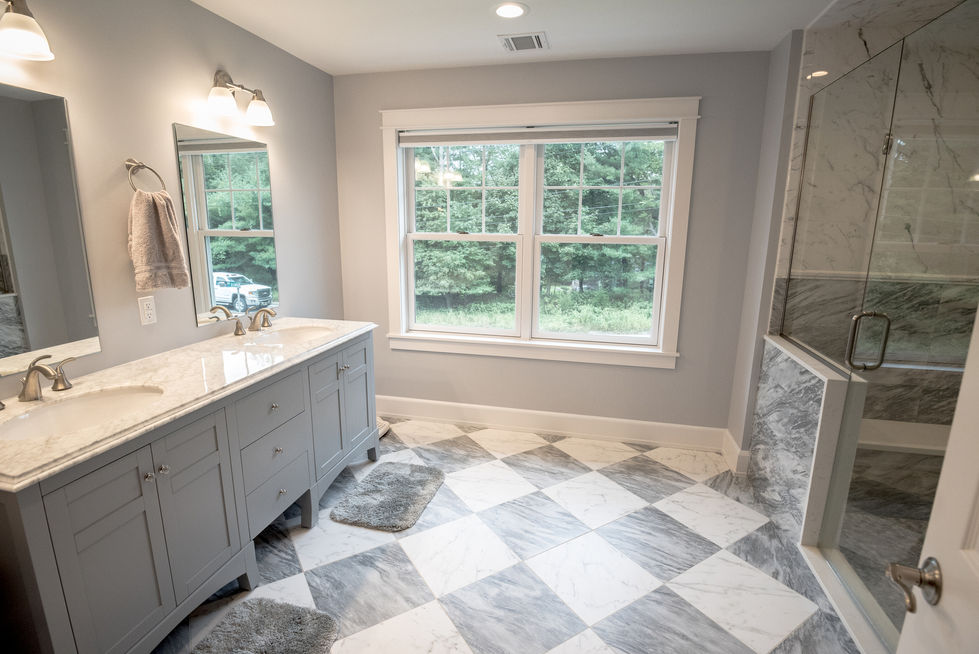 Bathroom with checkered floor and large window view.