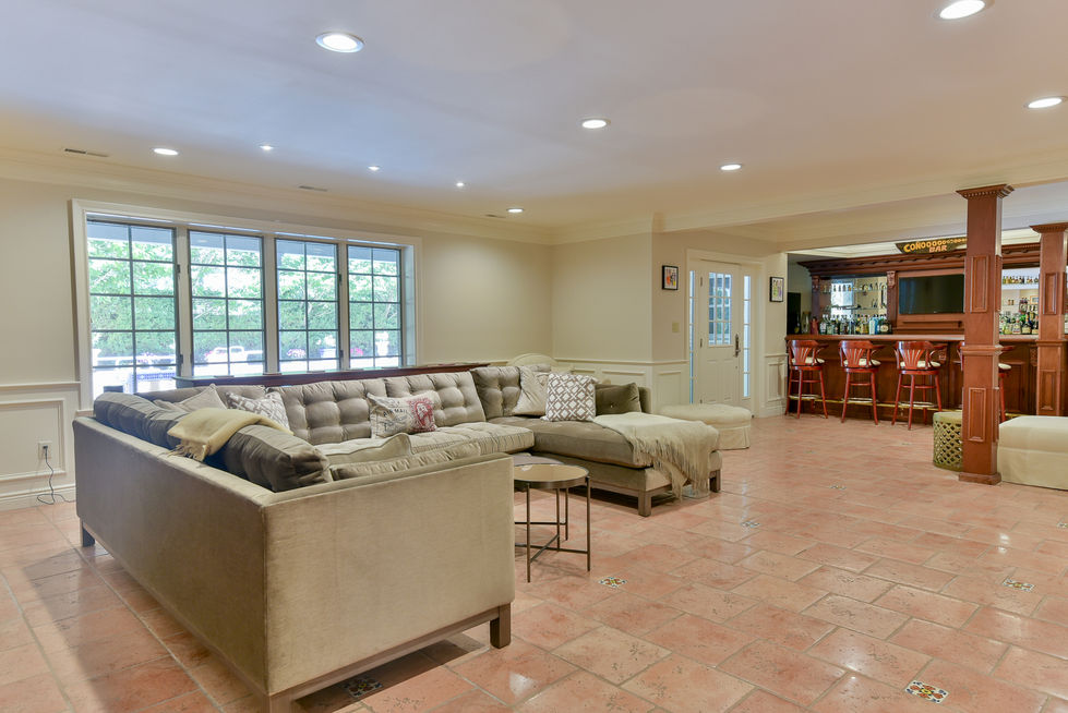 Cozy living room with sectional sofa and bar area.