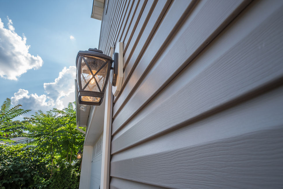 Outdoor wall lamp on house siding.