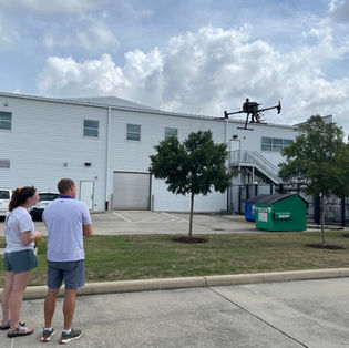Two people piloting a drone