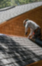 A Roofer Fixing Shingles Roof