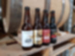 World First Abalone beer bottles displayed in front of a wooden beer barrel. Explore our historical archive releases.