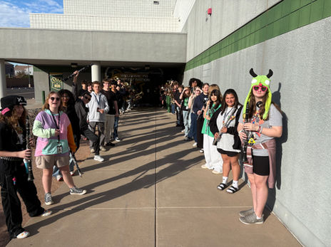 Students with musical instruments lining a walkway.