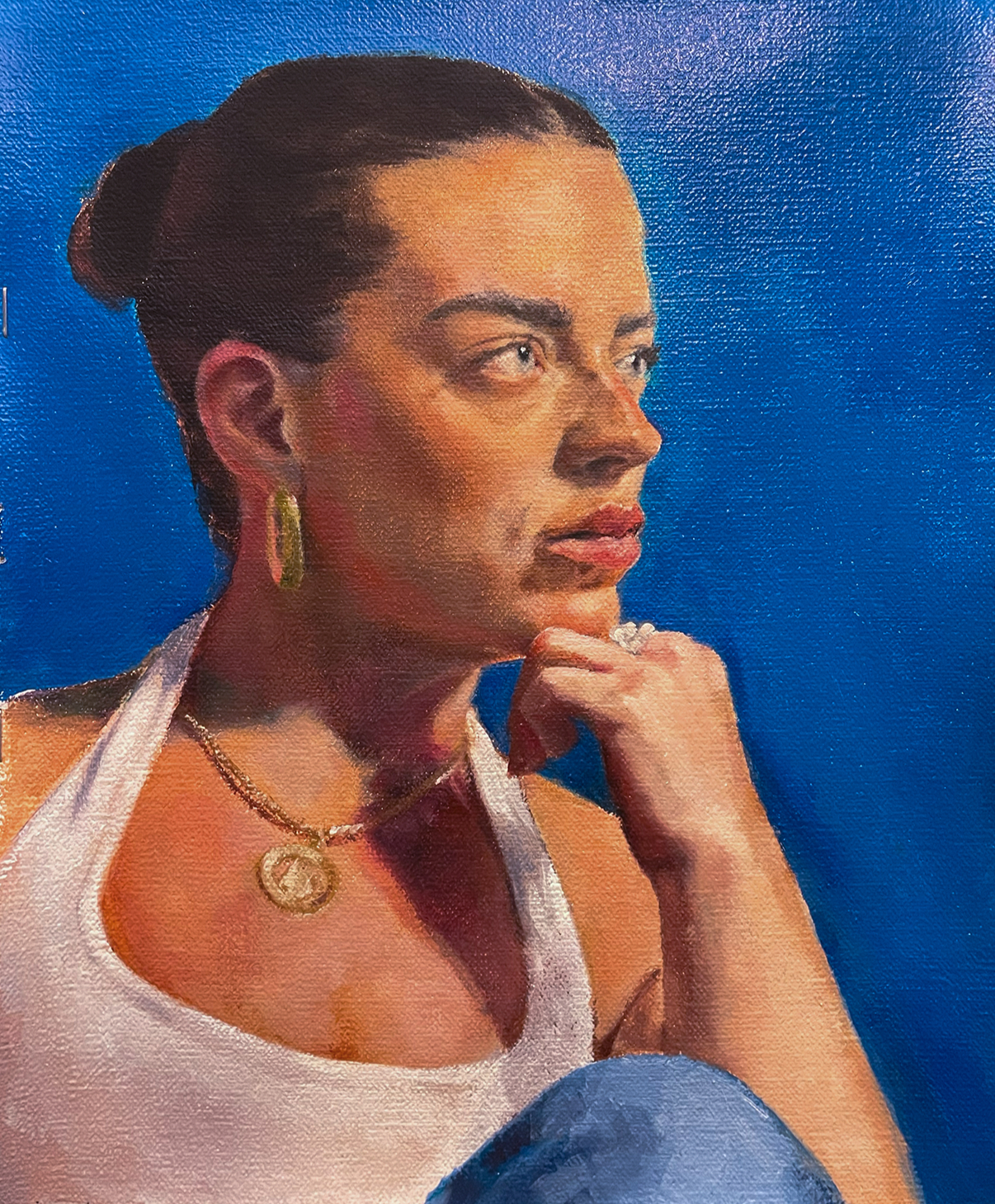 Oil painted portrait of Kathryn on a bright blue background