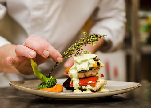 chef-placing-herb-gourmet-meal.jpg