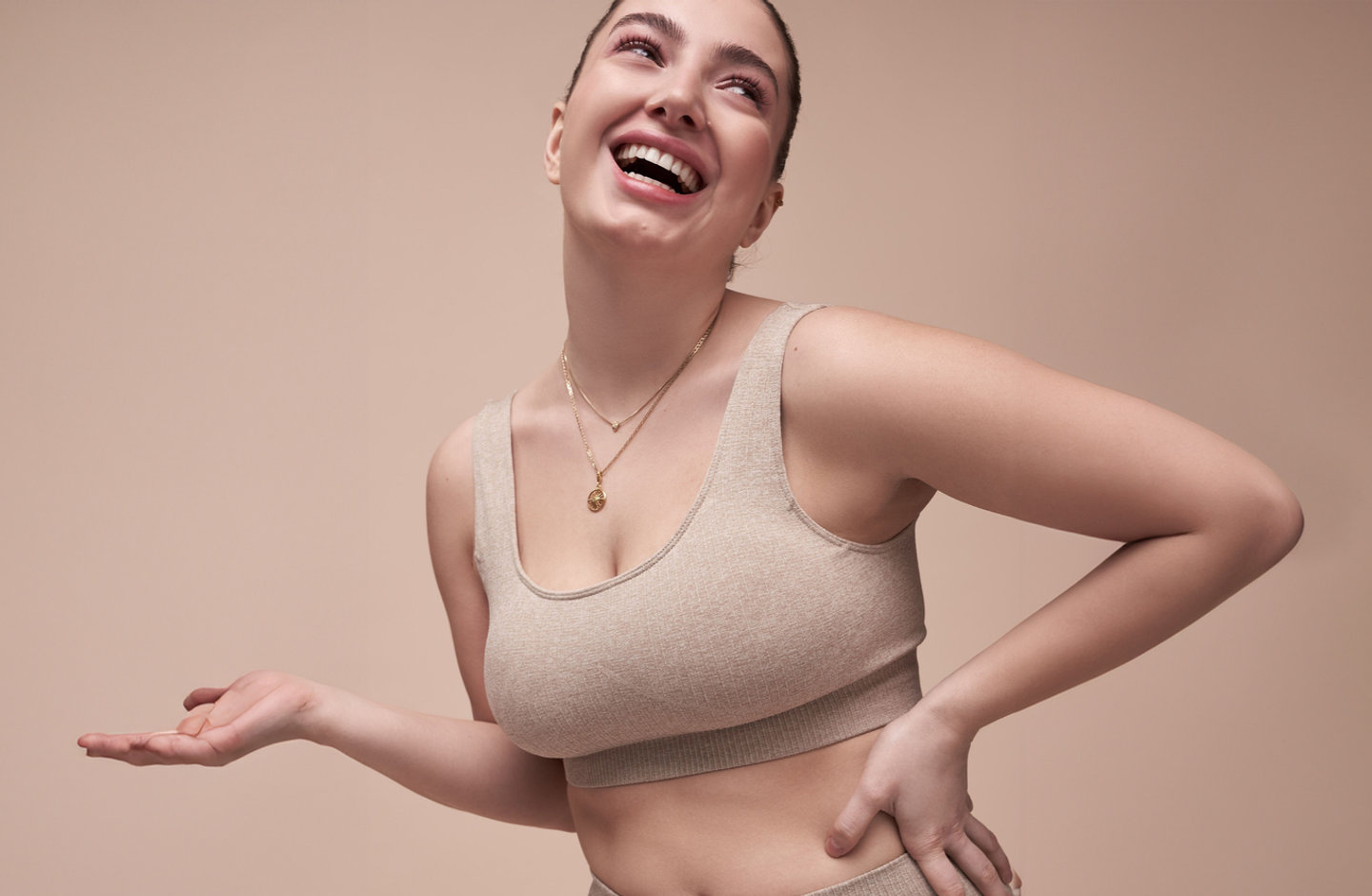 A smiling model in Kaimana activewear.