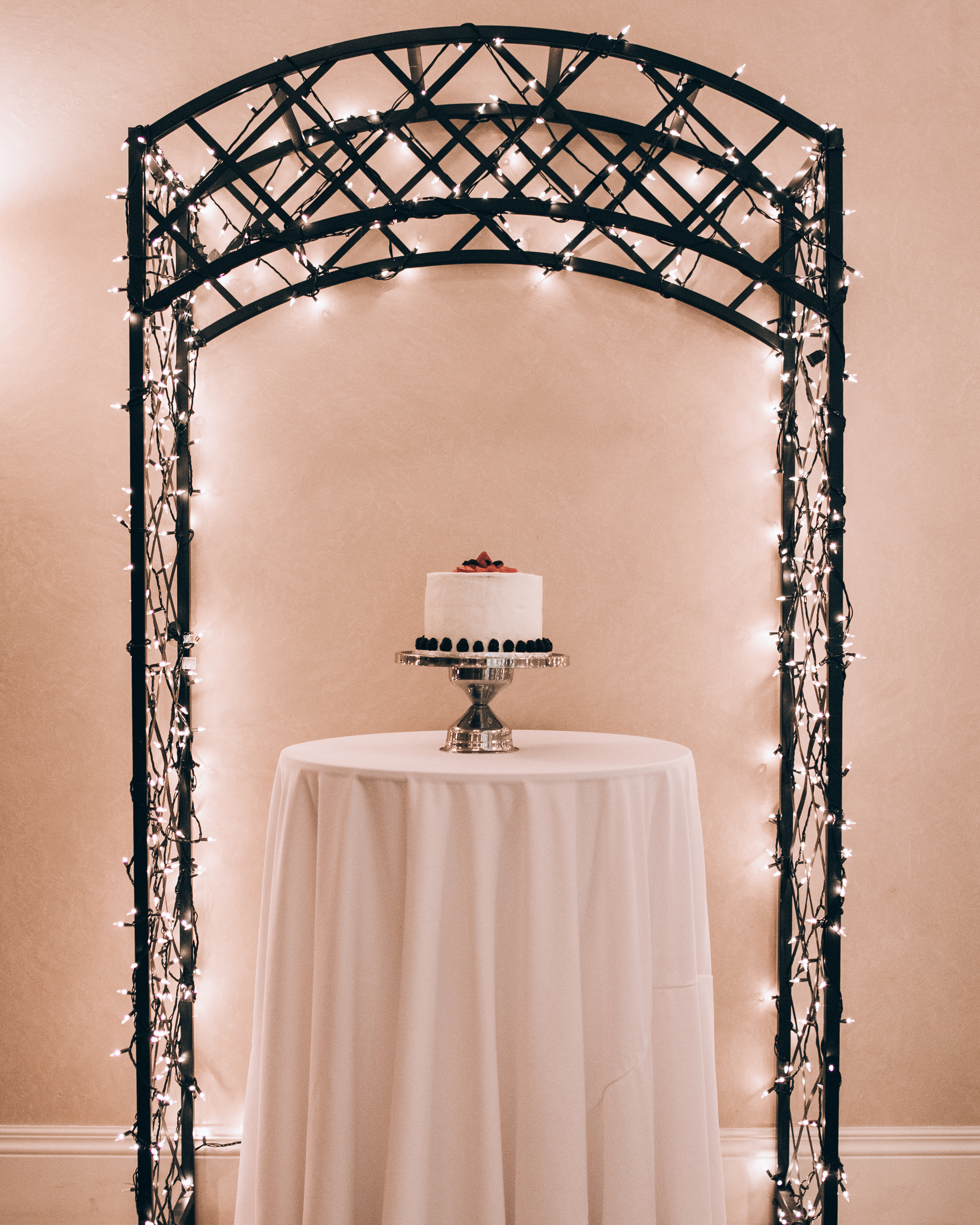 One of the venue's decorative arches, staged beside the included cake table.