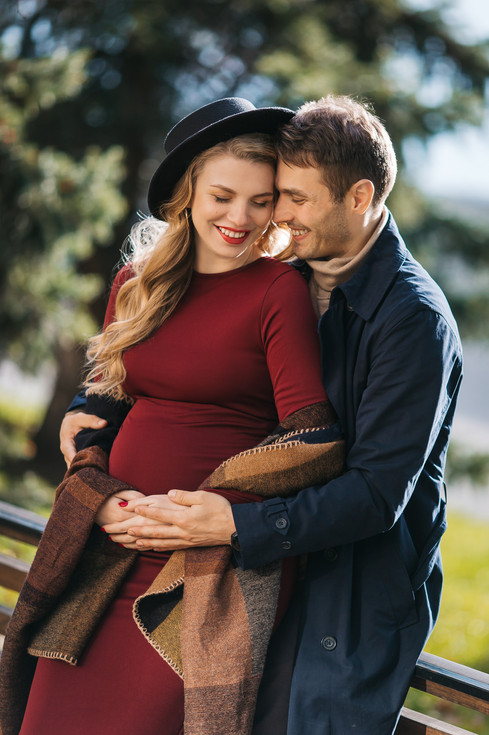 young-handsome-man-raincoat-hugs-his-pregnant-wife-red-dress-stylish-hat-park-th.jpeg