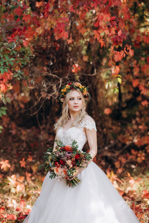 blonde-girl-wedding-dress-autumn-forest-against-background-wild-red-grapes.jpeg
