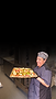 Smiling chef holding a tray of chopped vegetables