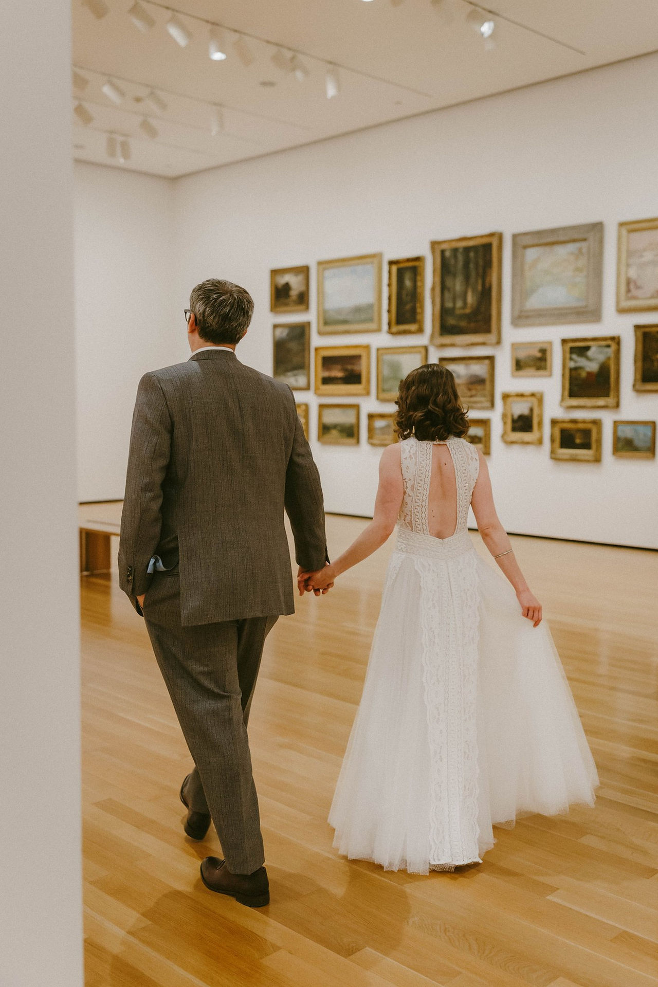 bride and groom in art gallery