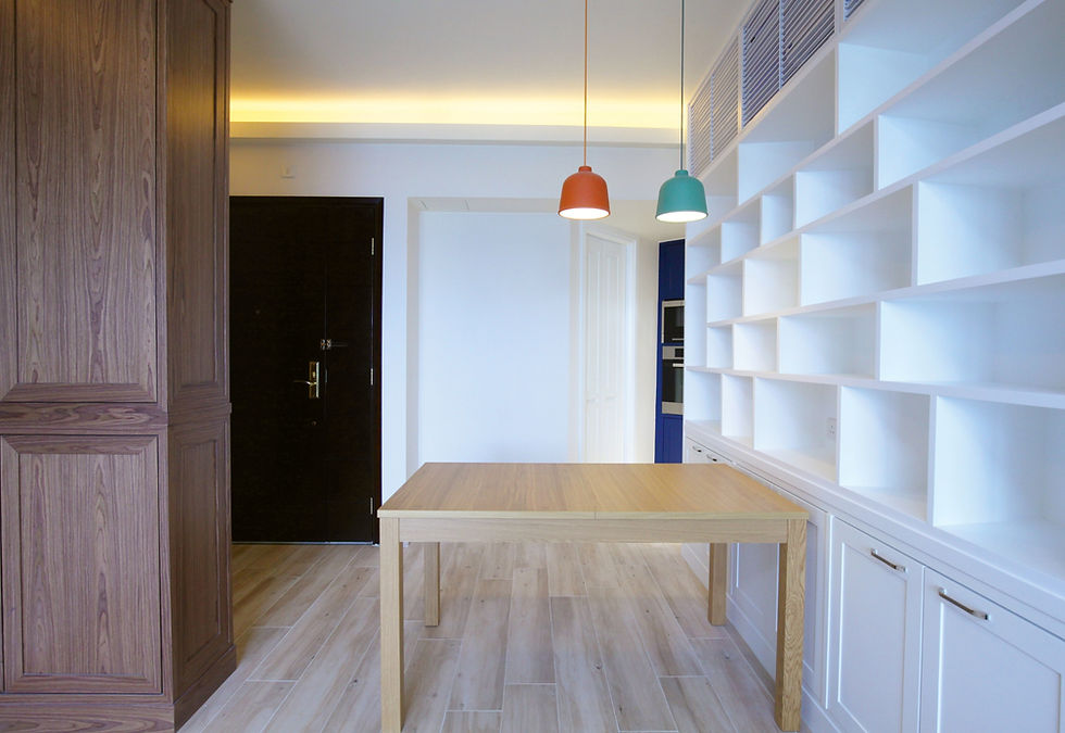 Minimalist dining area at Emerald Green Yuen Long by enochliving, with custom white shelving.