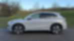 Static side profile shot of a grey Geely EX5 Max