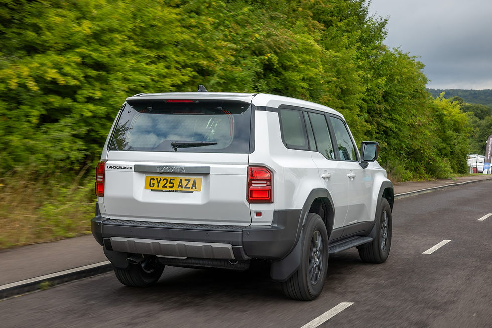Dynamic rear 3/4 shot of a white Toyota Land Cruiser Commercial