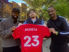 Kellyn Acosta (left) poses with a Chicago Fire jersey he gifted to Edgewater Castle FC alongside co-founders Andrew Swanson (middle) and James Kitia (right). Credit: Gareth Mullins, Tyler Navas
