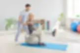 Physical therapist helps older man rehabilitate from lumbar spine surgery
