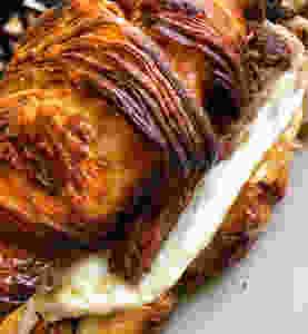 handmade croissant stuffed with fried egg and meats