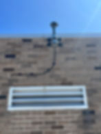 Close-up view of a GNSS receiver and antenna setup on a rooftop