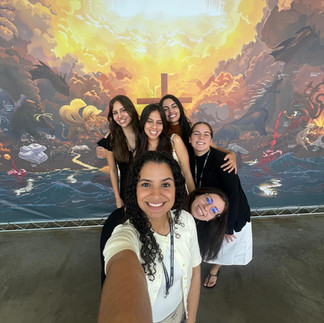 Woman taking selfie with friends in front of 24ft Banner in Brazil | The Story of Prophecy by Rebrand Prophecy Art