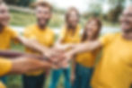 Multi ethnic young people team stacking hands together outside - International university