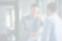 Businessman smiling and shaking another businessman's hand
