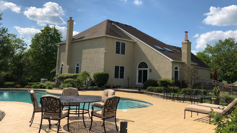 Large pool deck resurfaced with stamped concrete in warm earth tone