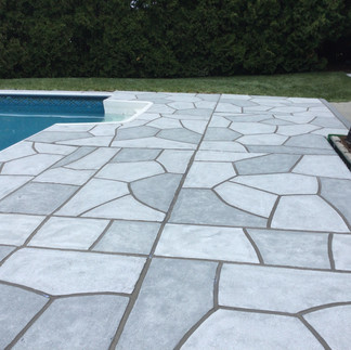 RenuKrete decorative concrete pool deck with a durable natural stone finish