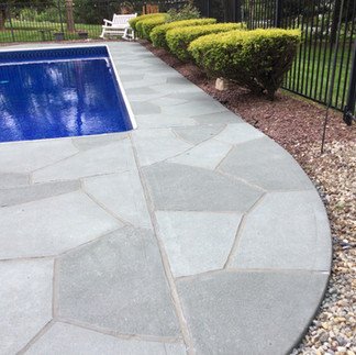 Backyard pool deck sculpted by RenuKrete to look like natural stone