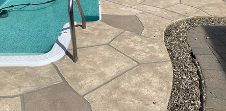 Sandstone finish flowing from the spa edge into the surrounding deck