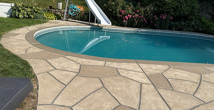 Sandstone finish wrapping the pool with smooth, rounded transitions