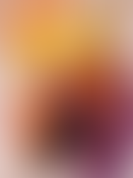 A paint palette showing paint in a range of colours from white and yellow to orange, umber and purple.