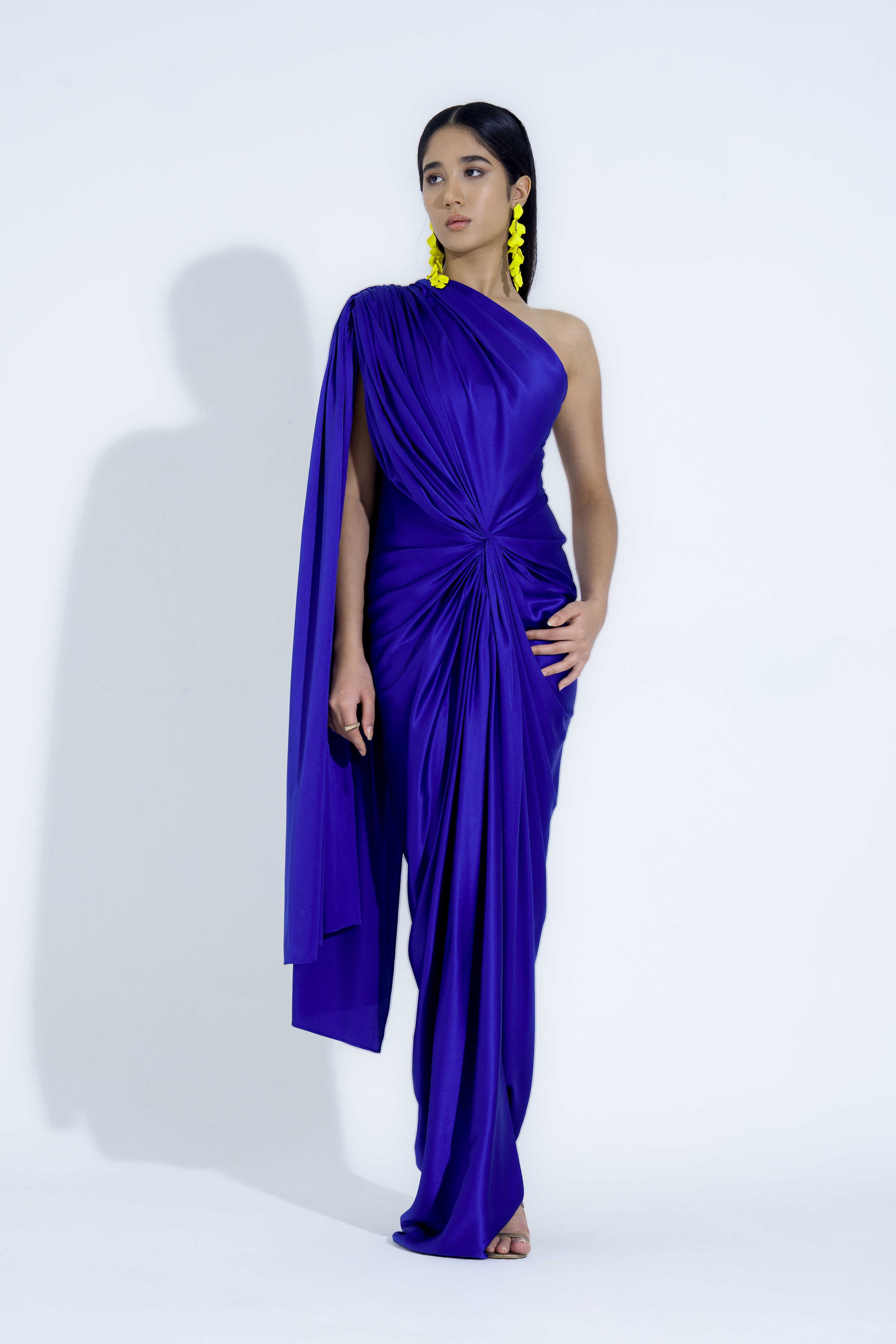 Royal Blue Satin Gown with Flowing Shoulder Trail Detail.