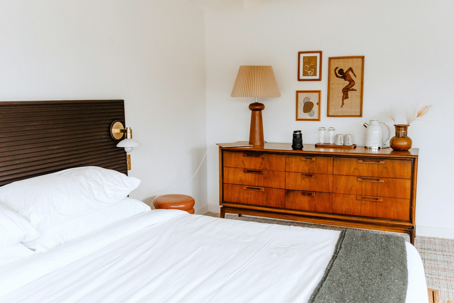 A neatly made bed with white linen in a welcoming guest room