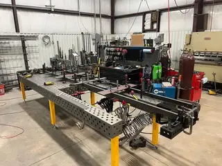 Nitrided 3D modular welding table surface with precision hole grid in fabrication workshop