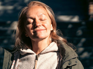 Woman in midlife peacefully reflecting on her next chapter