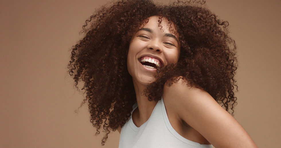 mixed-race-black-woman-portrait-with-big-afro-hair-curly-hair-beige-background-natural-lau