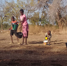 children brothers and sisters working on a community garden bed