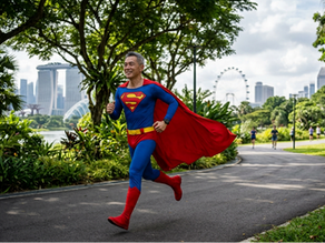A man in a superman costume running